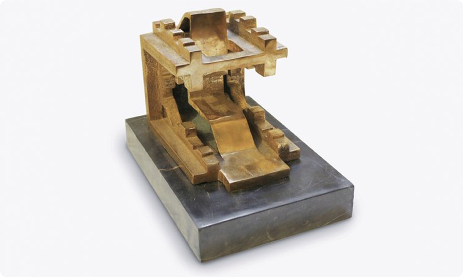 Inverted City: a dense bronze block of stacked architectural forms on a steel base