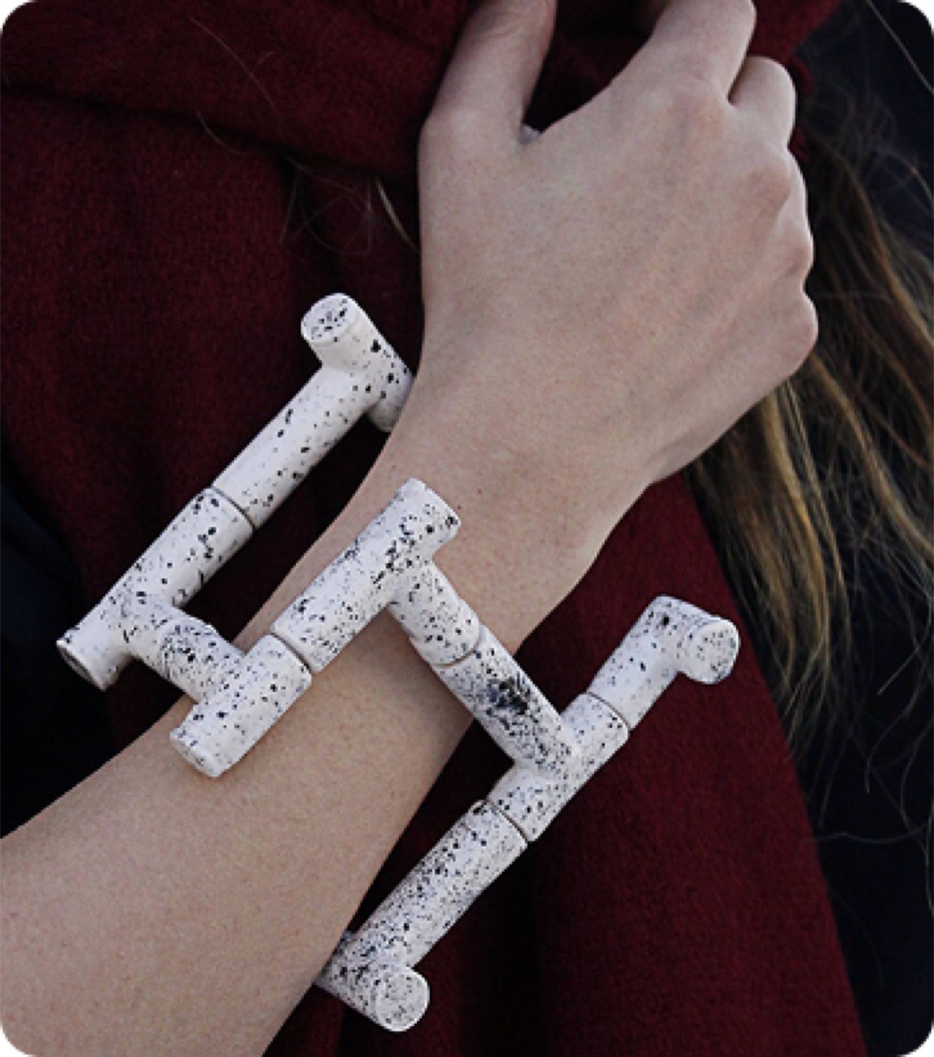 The cuff worn against a deep red sleeve