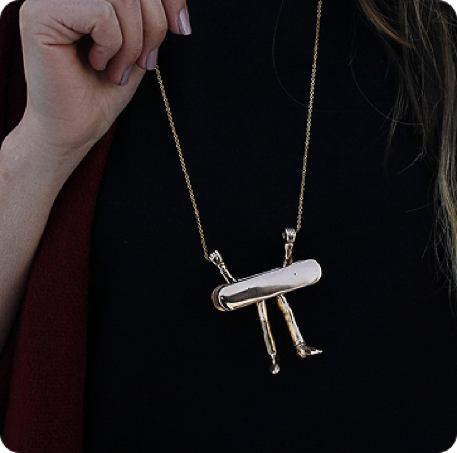 The figure pendant worn against a black dress