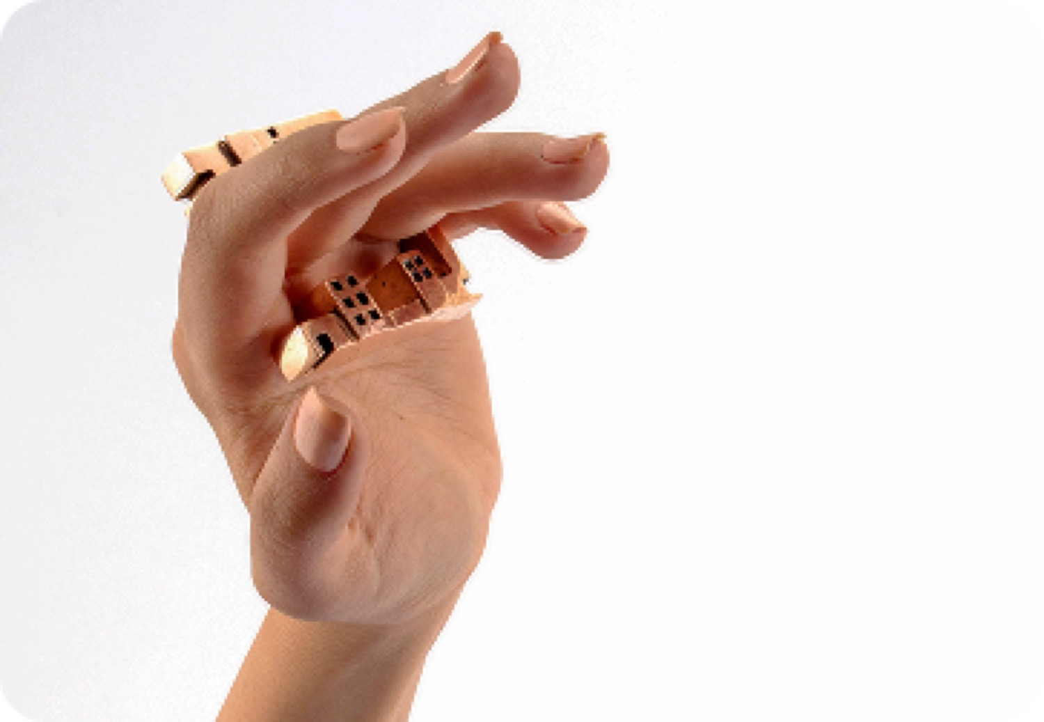 Architectural gold rings worn across the fingers