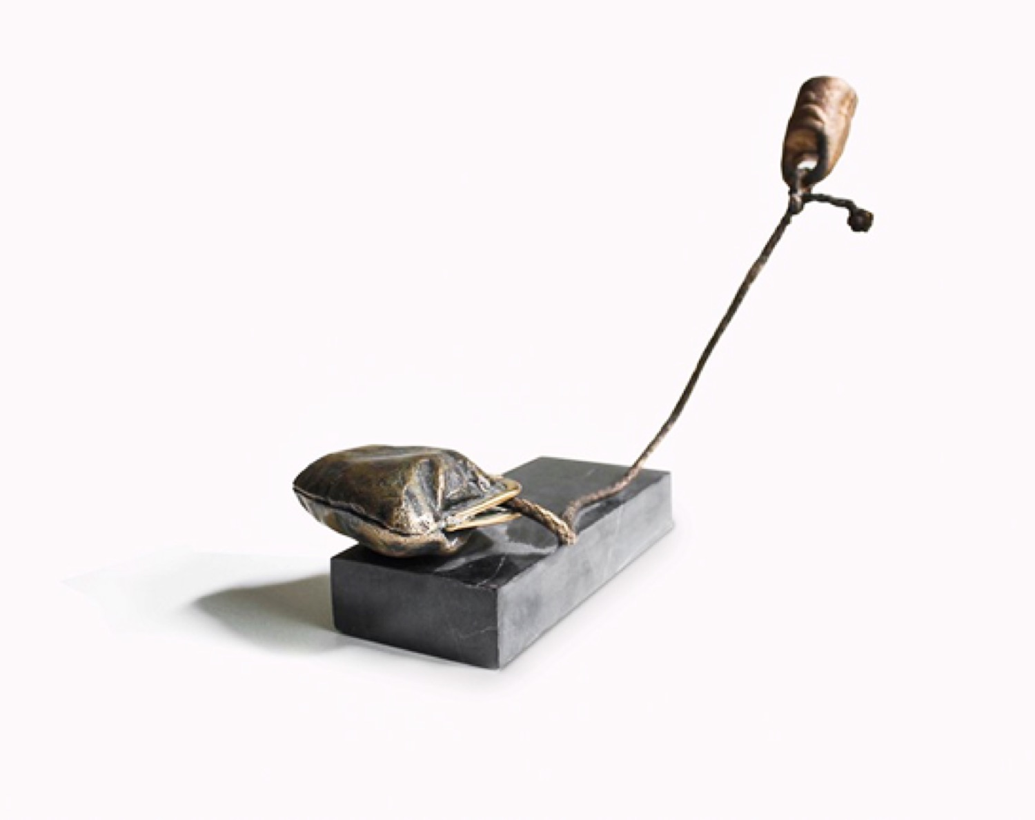 Weightlessness: a small bronze form suspended from a thin arm above a black base