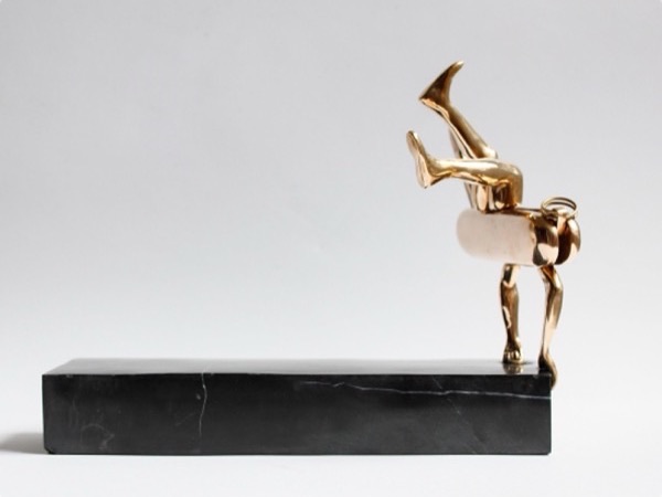 Edge, a bronze figure tipping forward on a long black base